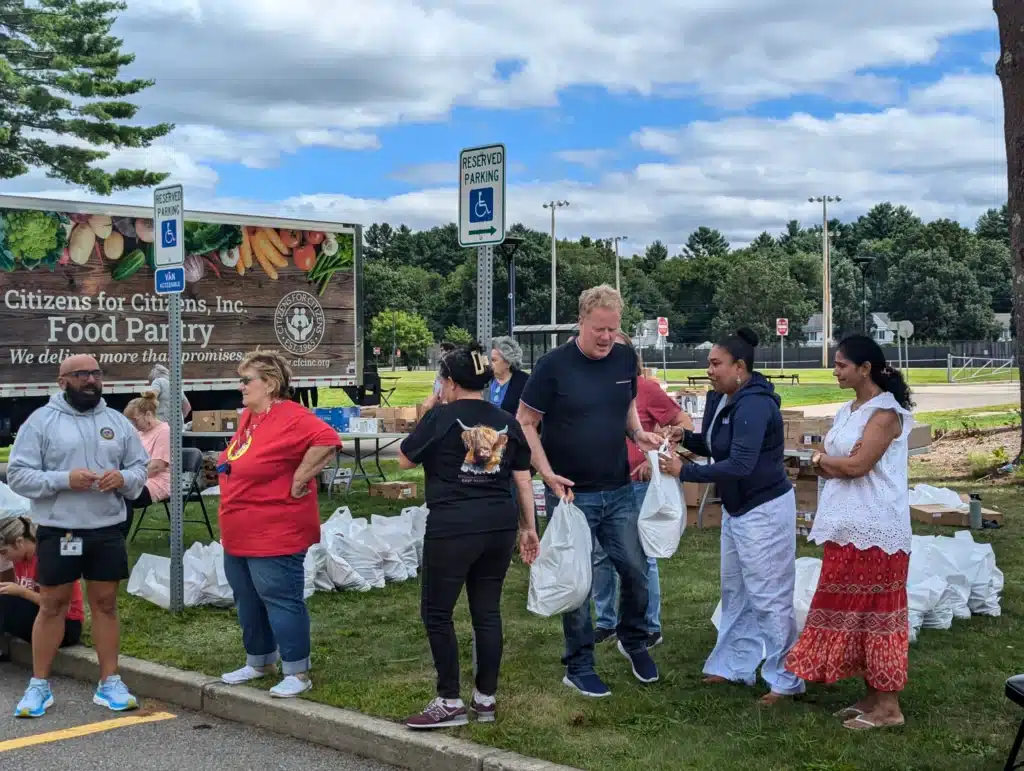 Taunton Mobile Pantry food pantry volunteers running bags of food to a car